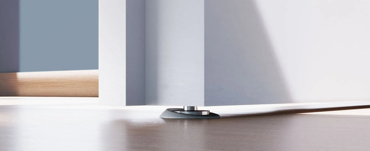 Concealed floor door stop with low profile magnetic floor catch.