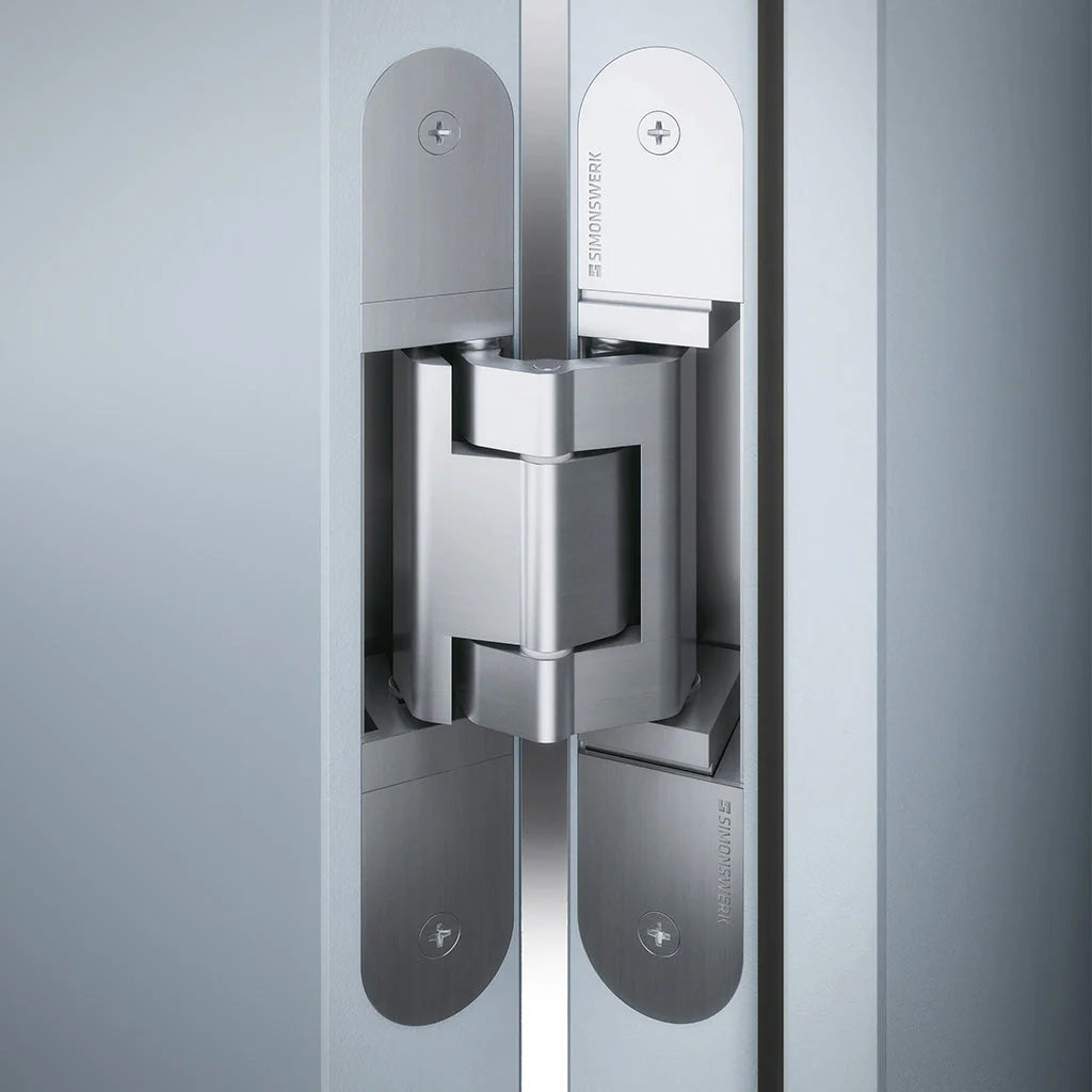 Simonswerk Tectus TE 340 3D concealed door hinge installed in a white wood door.