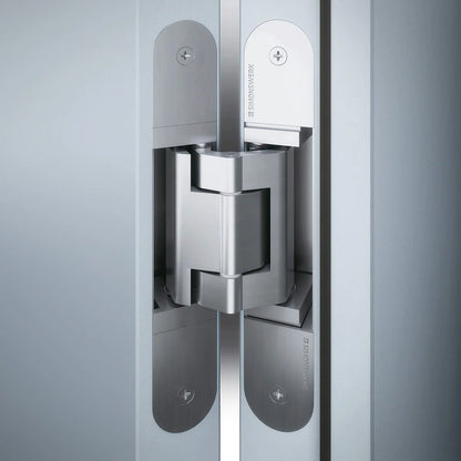 Simonswerk Tectus TE 340 3D concealed door hinge installed in a white wood door.