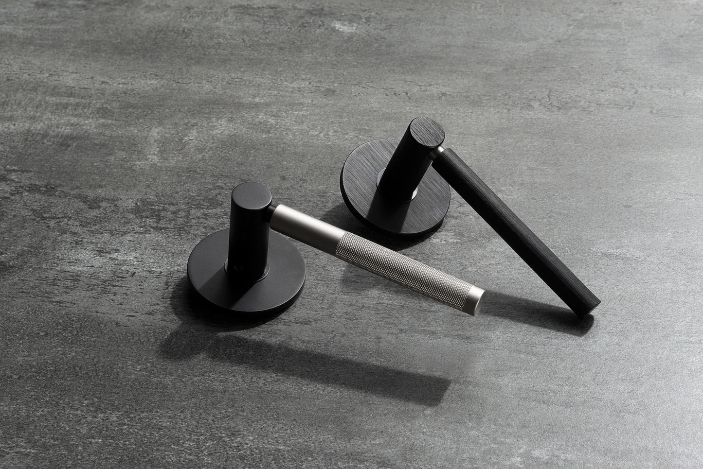 M&T NOMAD European door hardware in brushed and smooth black finishs, handles in smooth and knurled finishes.