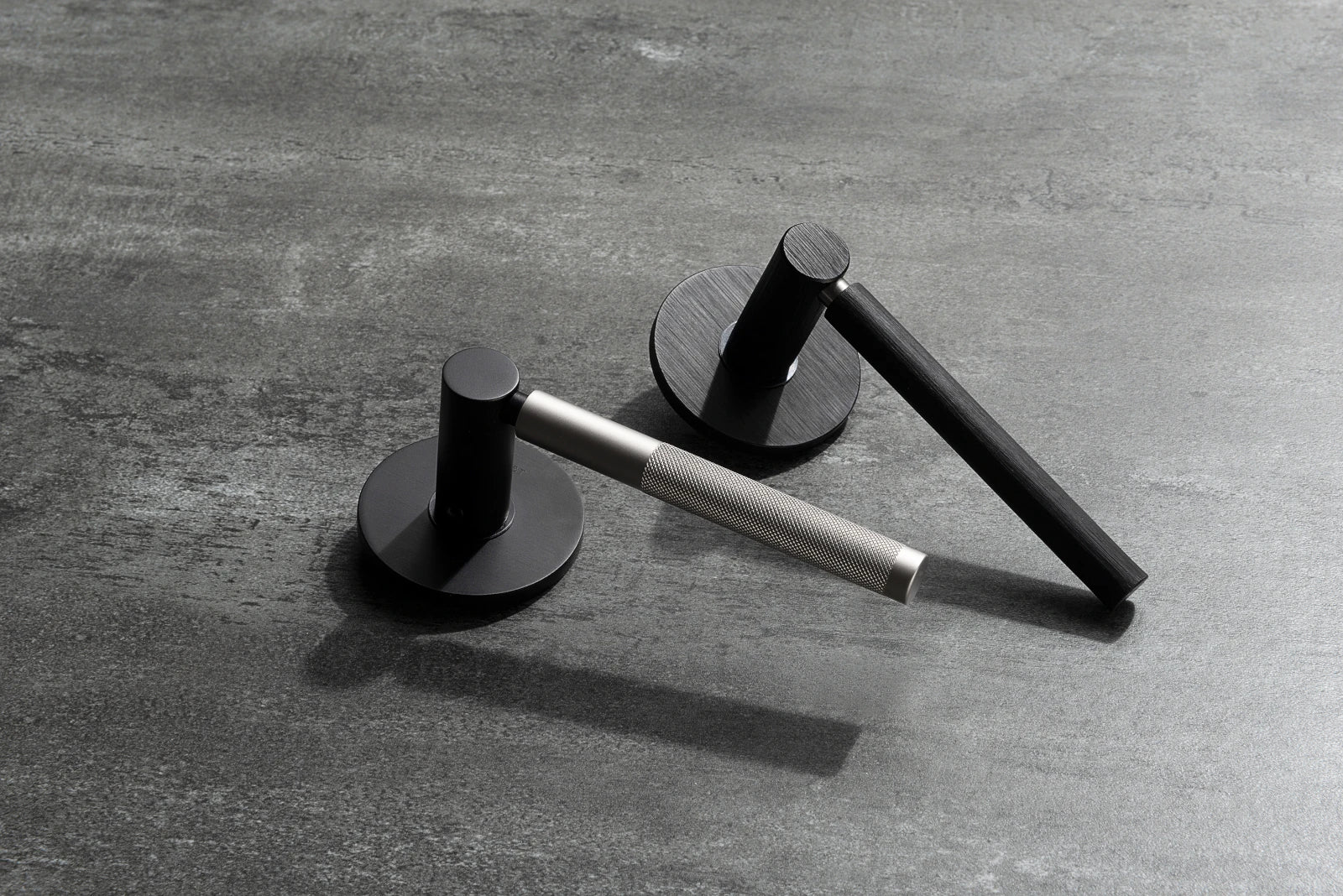 M&T NOMAD European door hardware in brushed and smooth black finishs, handles in smooth and knurled finishes.