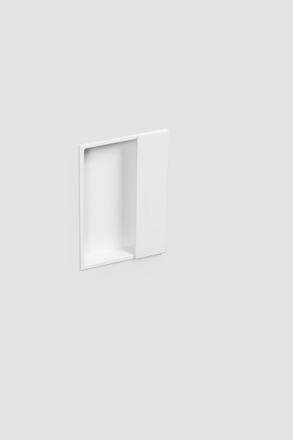 Verum Miles, a rectangular minimalist Italian white recessed door pull for sliding barn doors, pocket doors, and single/double closet doors.