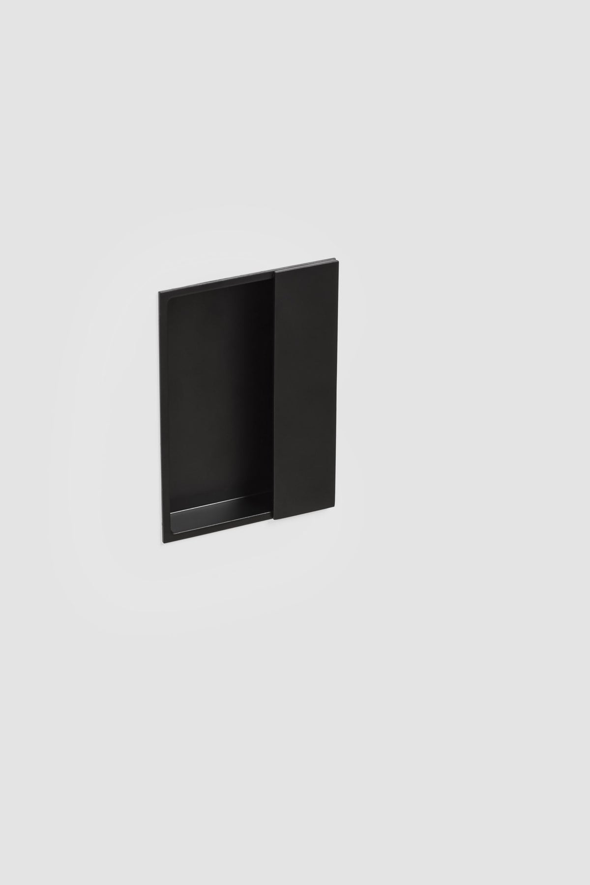Verum Miles, a rectangular minimalist Italian matte black recessed door pull for sliding barn doors, pocket doors, and single/double closet doors.