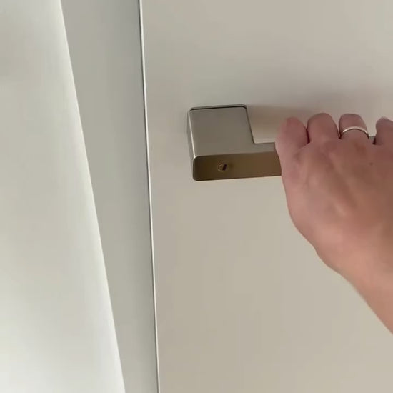 Demonstration of the integrated privacy lock in Griffwerk R8 One door lever handle. The door privacy lock is integrated in the neck of the lever, and works as a slide switch. Emergency unlock is shown on the exterior side: you can open an interior privacy lock from the outside using a small flathead screwdriver, paperclip, or a similar object.