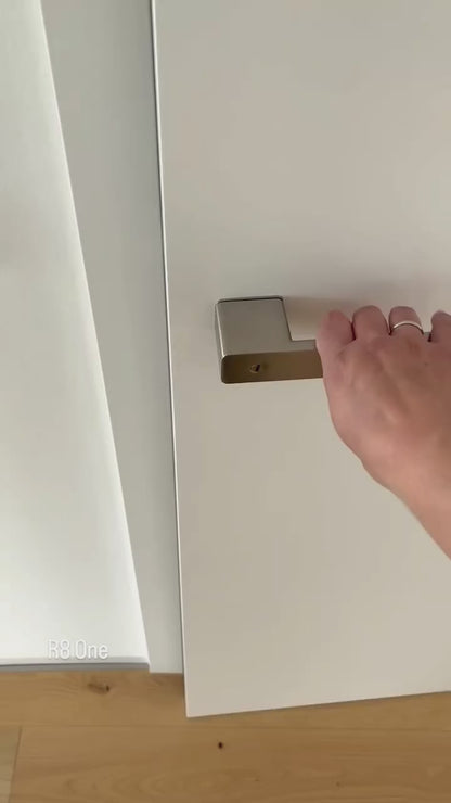 Demonstration of the integrated privacy lock in Griffwerk R8 One door lever handle. The door privacy lock is integrated in the neck of the lever, and works as a slide switch. Emergency unlock is shown on the exterior side: you can open an interior privacy lock from the outside using a small flathead screwdriver, paperclip, or a similar object.